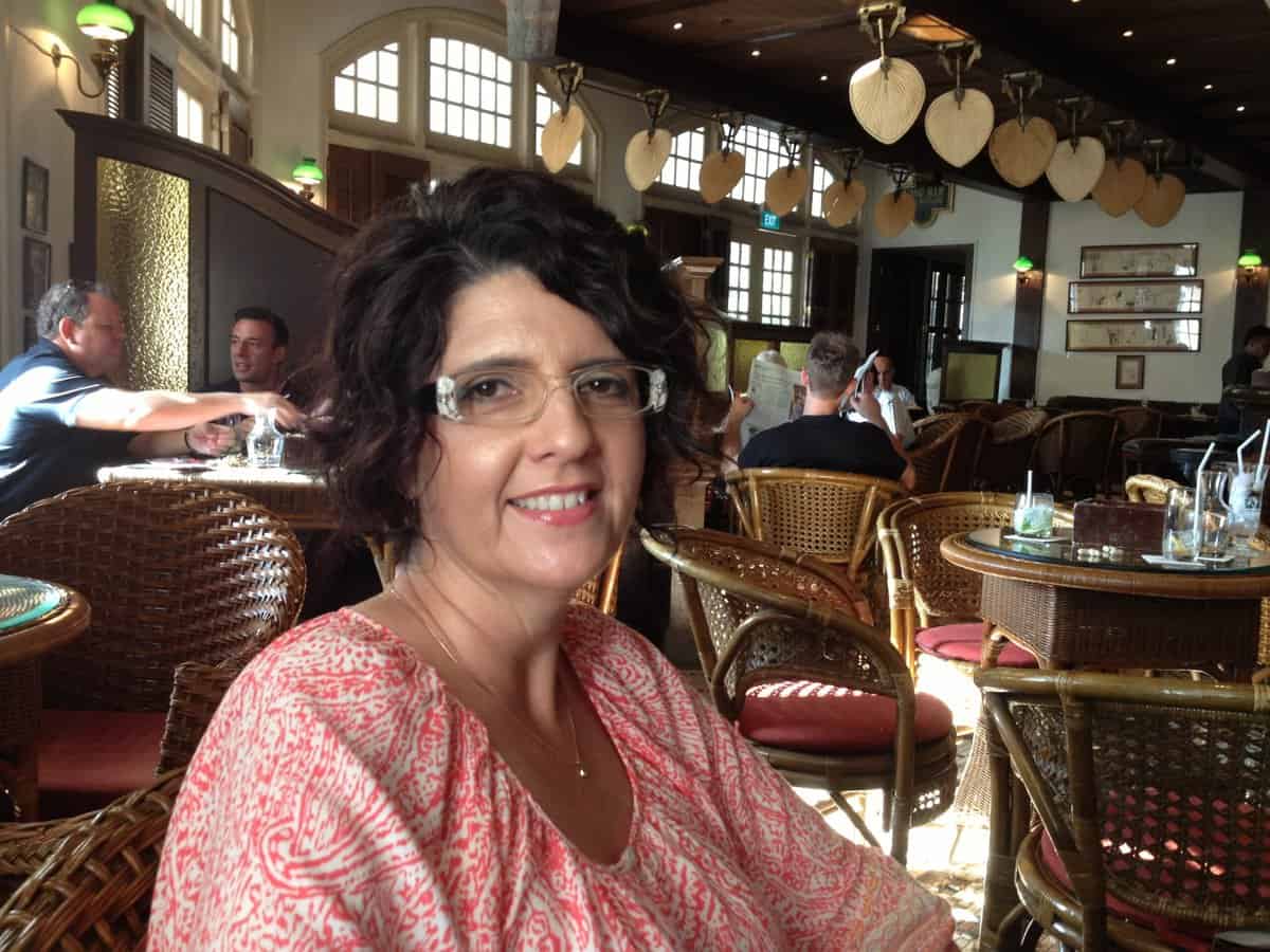 A woman sitting at a table in a restaurant.